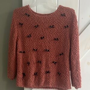 Cozy Pink Textured Sweater with Black Bow and Pearl Accents